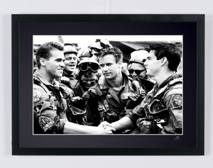 Top Gun (1986) - Tom Cruise (Maverick) & Val Kilmer (Iceman), surrounded by the pilots — framed cinema photograph