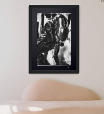Alien (1979) — The Xenomorph, a creature with an elongated head, seen in profile, framed cinema photograph in black and white, in your home.