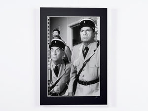 The Gendarme of Saint-Tropez - Louis de Funès (Cruchot) and a gendarme of the brigade (black and white) — framed cinema photograph