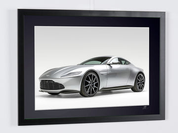 James Bond 007 : Spectre (2015) — Aston Martin DB10, car seen from a front three-quarter angle against a pale background, framed cinema photograph in colour, frame viewed in perspective from the right.