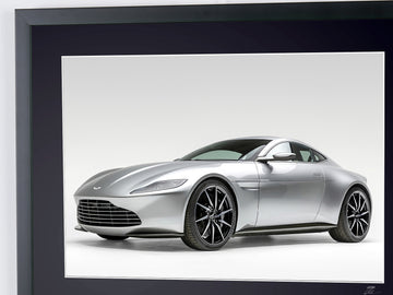 James Bond 007 : Spectre (2015) — Aston Martin DB10, car seen from a front three-quarter angle against a pale background, framed cinema photograph in colour, detail of the upper photograph and frame.