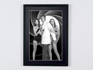 James Bond - The Man with the Golden Gun - Roger Moore, Maud Adams and Britt Ekland on a promotional photo shoot — framed cinema photograph