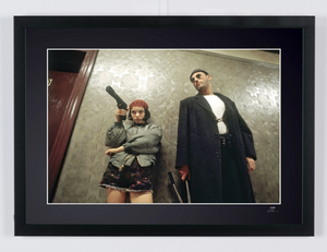 Léon: The Professional (1994) - Jean Reno (Léon) & Natalie Portman (Mathilda), armed in the hallway (colour) — framed cinema photograph
