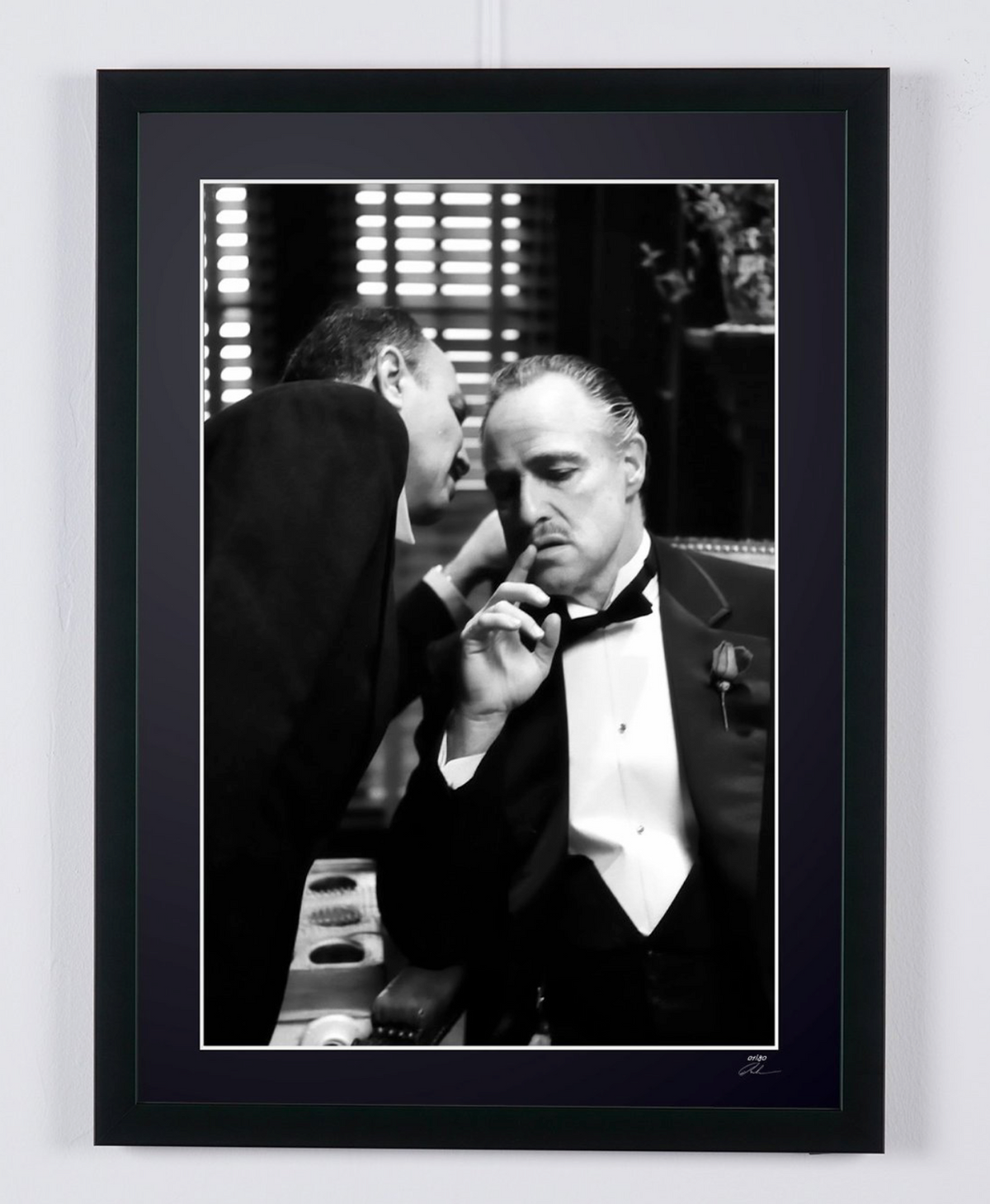 Marlon Brando in The Godfather (1972), Don Corleone listening to a man leaning towards his ear, framed cinema photograph in black and white, front view.